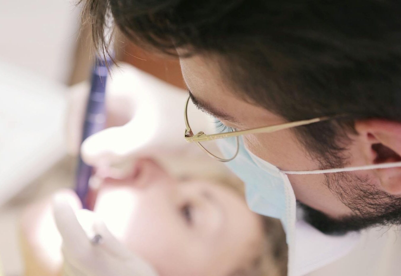 Male Dentist Working on Woman's Teeth